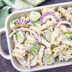 Cucumber Pasta Salad with onions in white serving dish