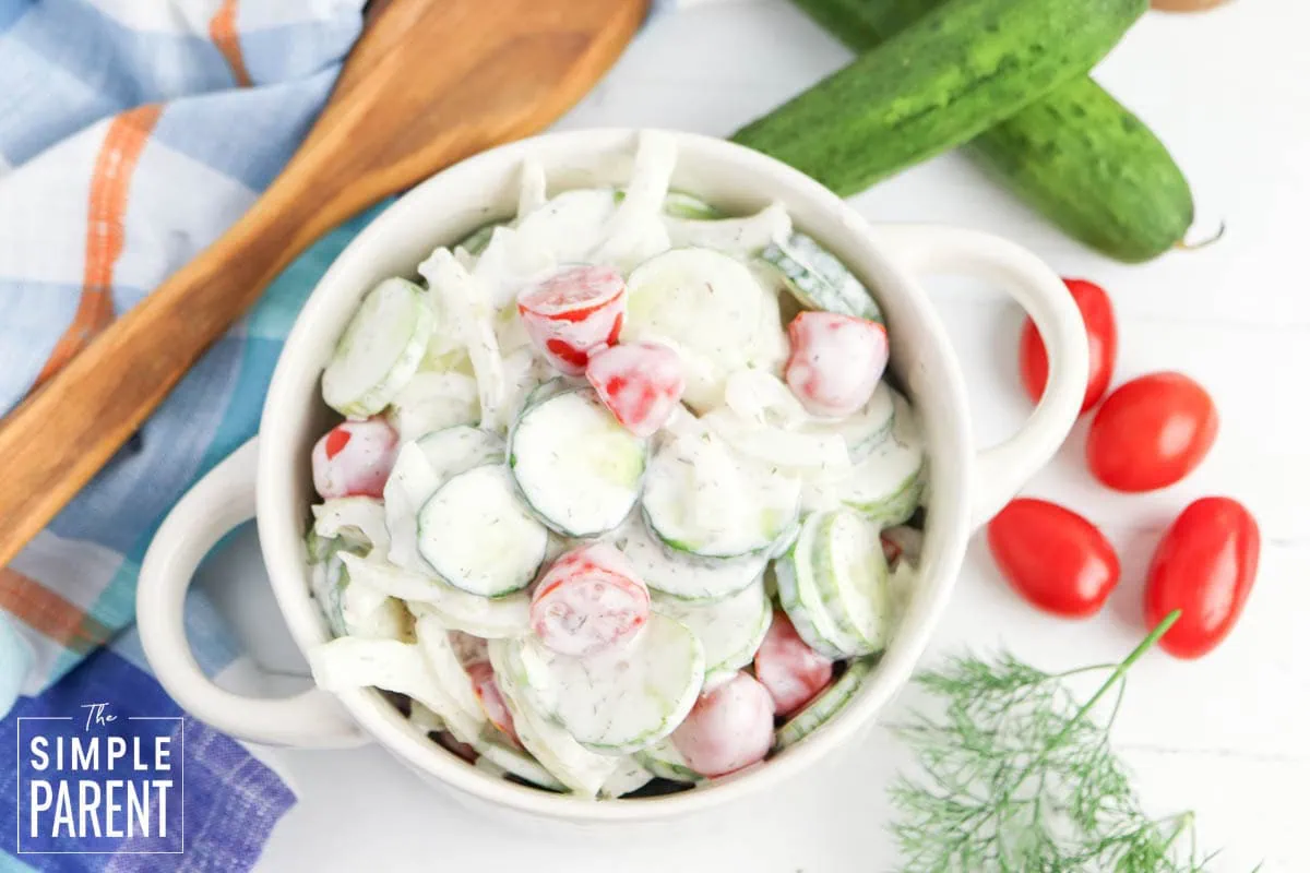 cucumber tomato salad in round white bowl