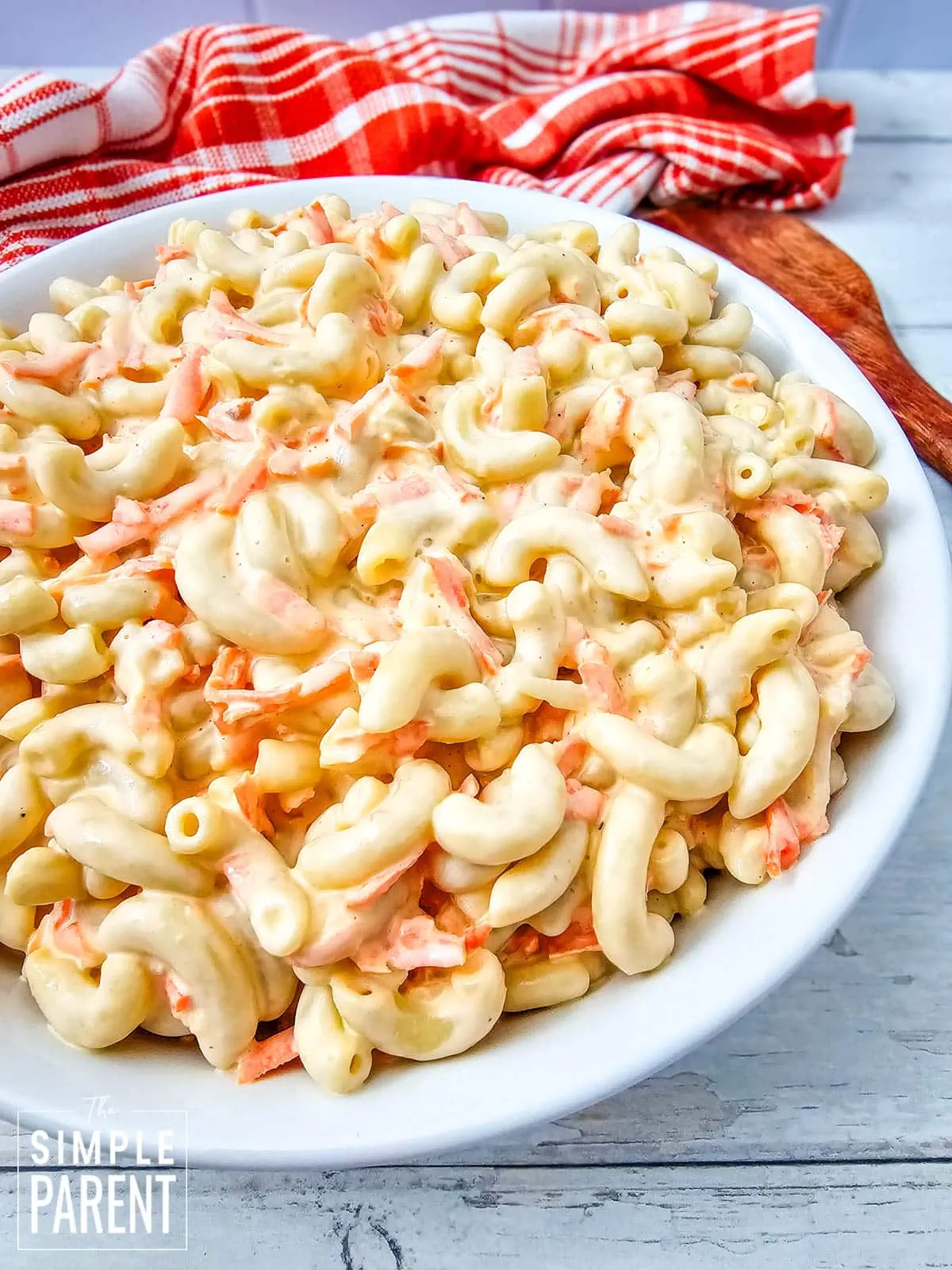 ono hawaiian macaroni salad in white serving dish with red dishcloth