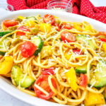 Cold spaghetti salad in white serving bowl