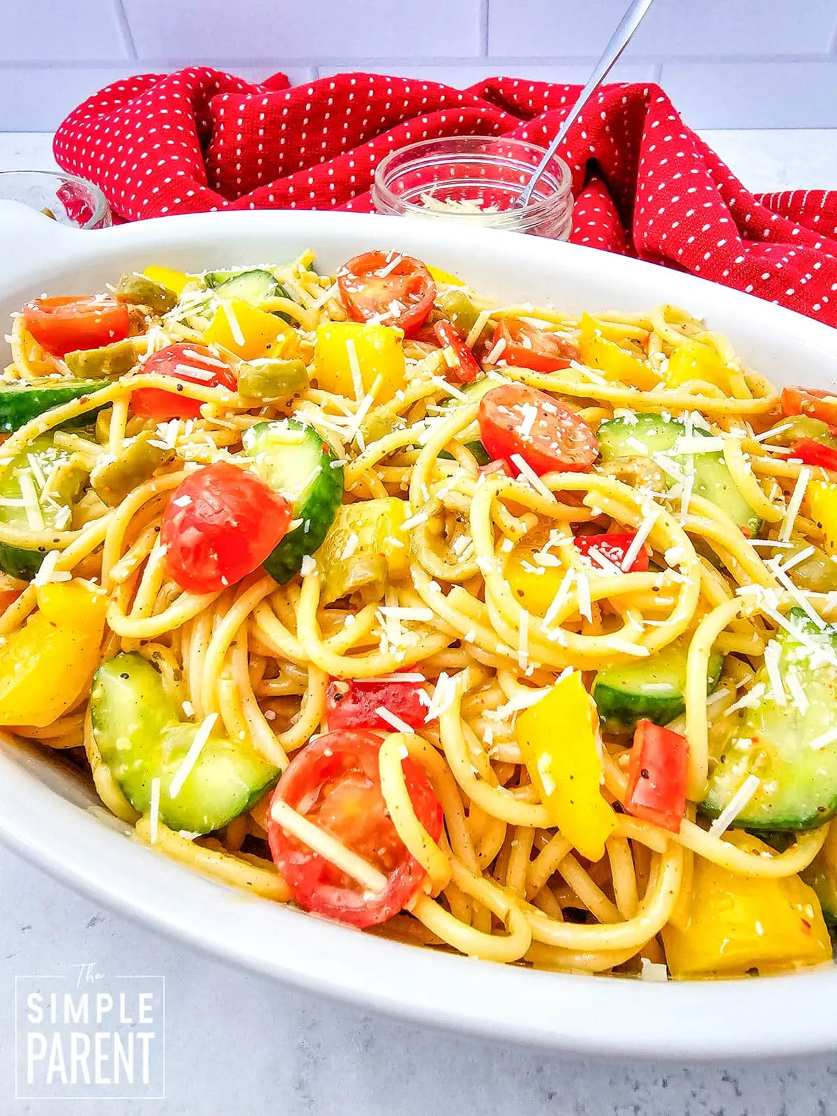 Cold spaghetti salad in white serving bowl