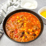 7 Can Taco Soup in black bowl on gray counter top