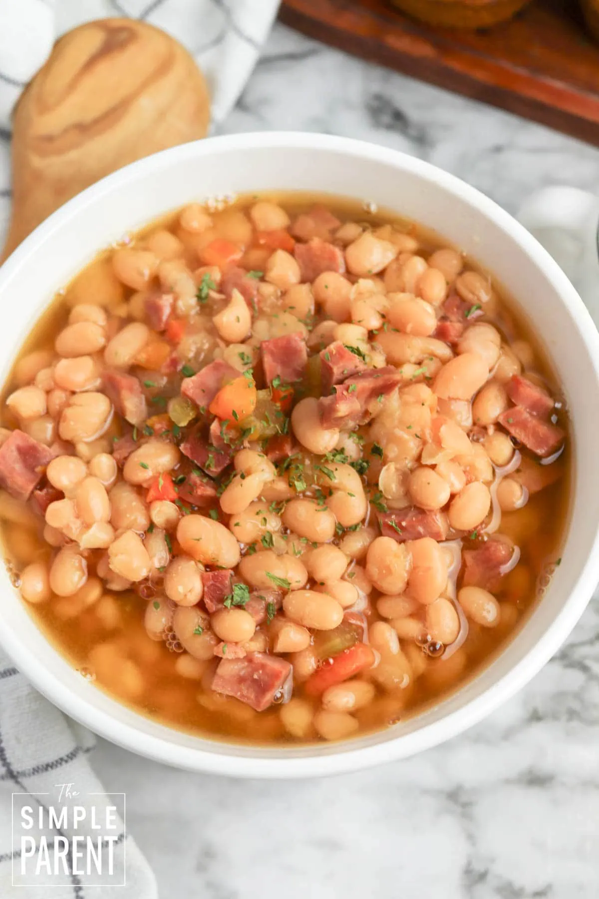 One pot ham soup in white slow cooker bowl