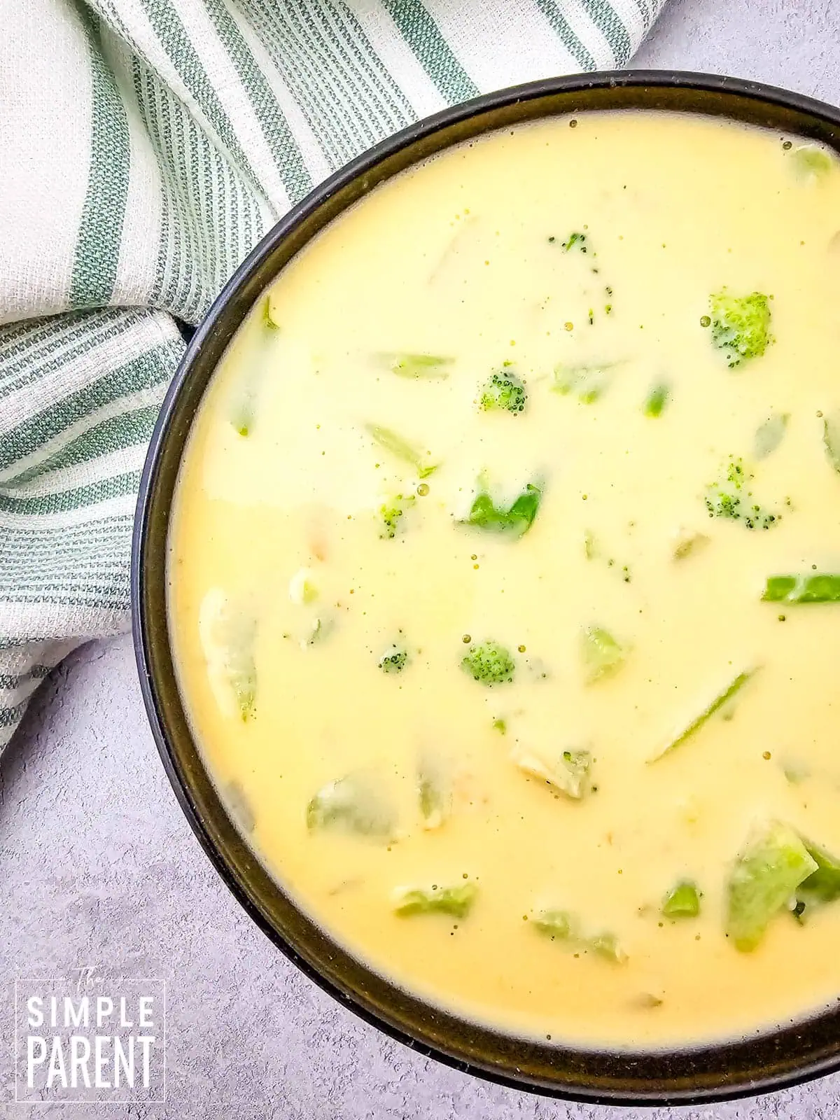 Easy broccoli and cheese soup in dark bowl on gray vounter