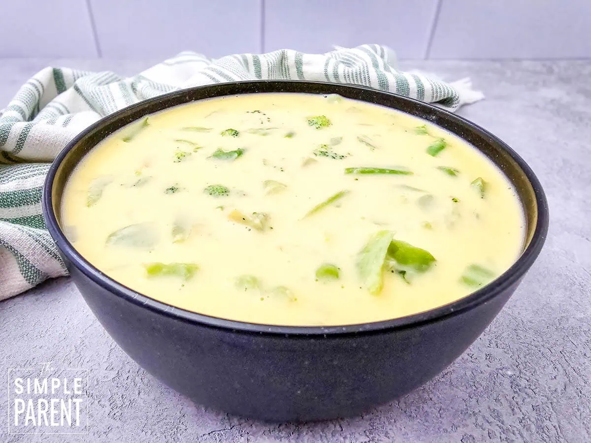 Homemade broccoli cheese soup in black bowl