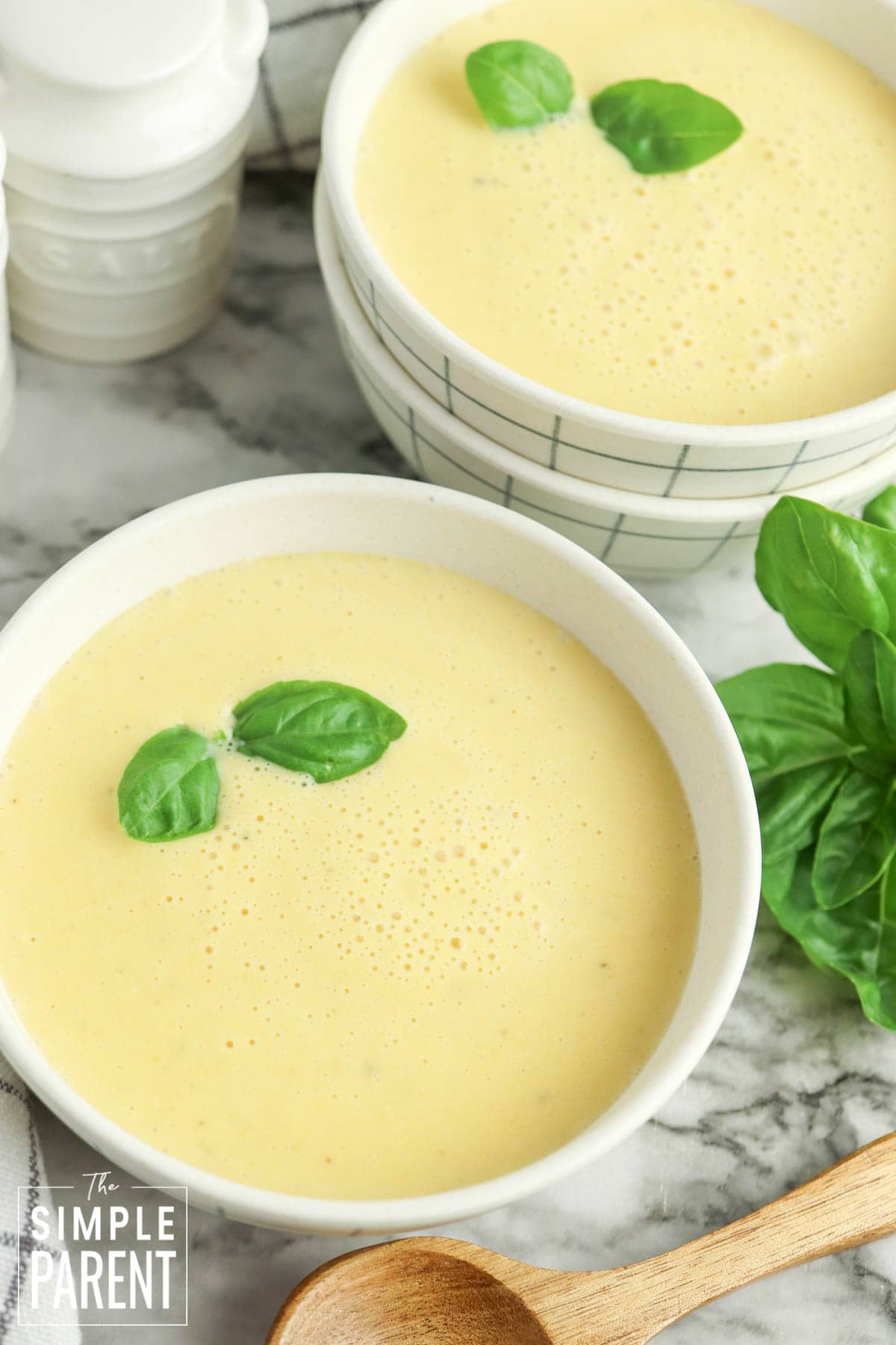 Two bowls of butternut squash soup in white bowls