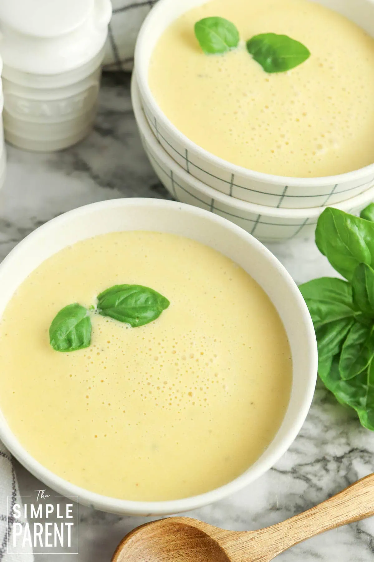 Two bowls of butternut squash soup in white bowls