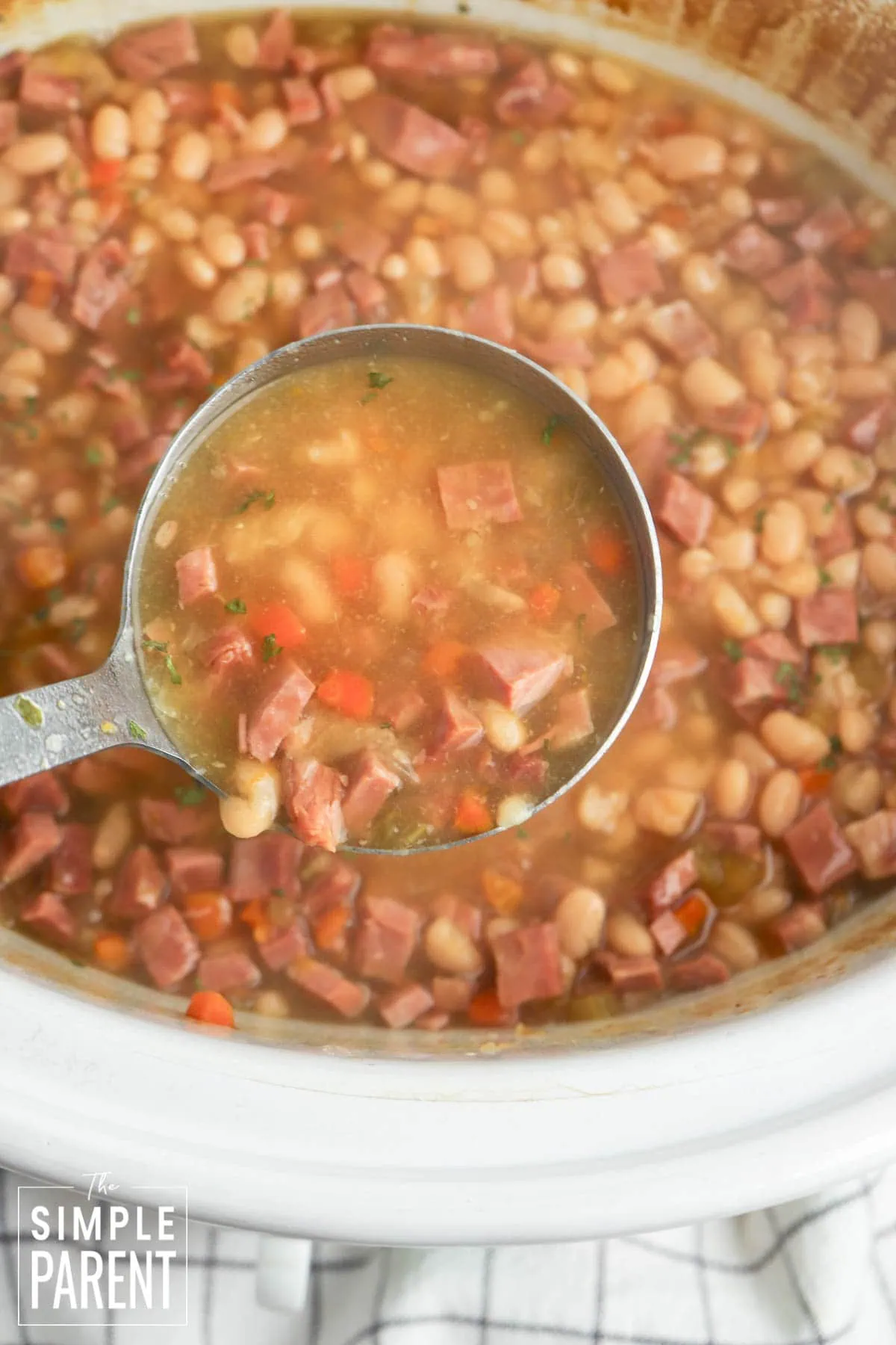 One pot ham and bean soup in Crockpot with ladle