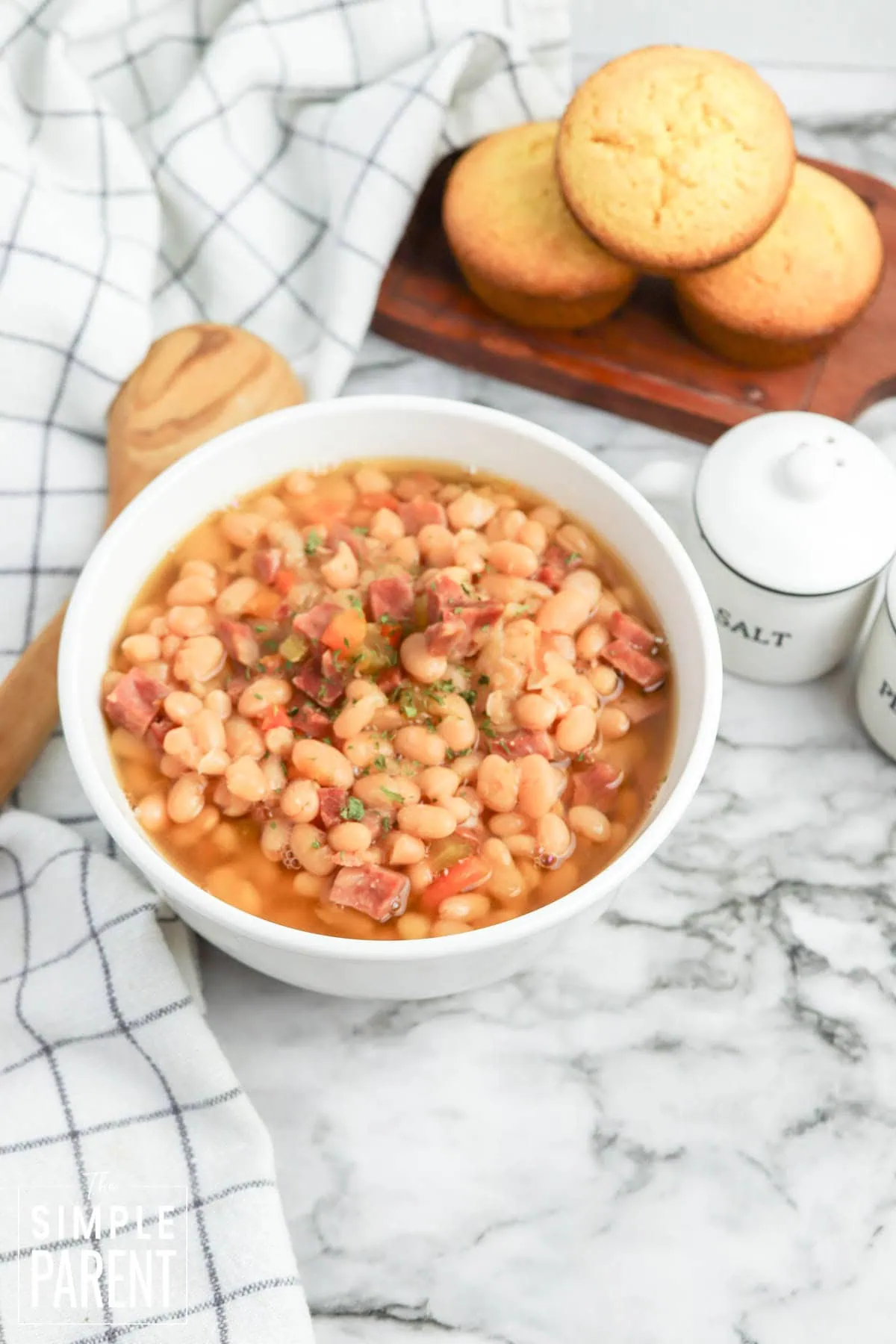 Slow Cooker Ham and Bean Soup in white bowl with cornbread