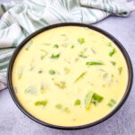Velveeta Broccoli Cheese Soup in black bowl on gray counter